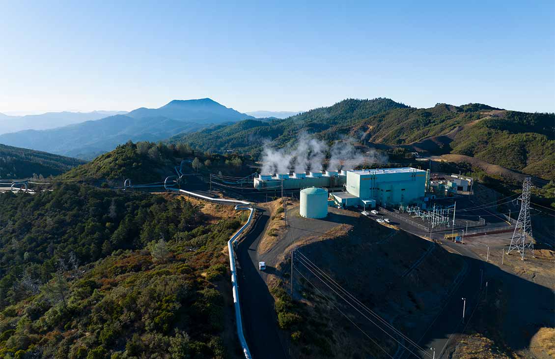 a family and children playing outside on a tubular architectural piece